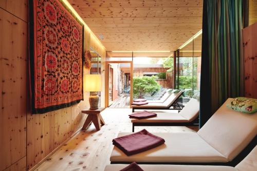 a living room with couches and a rug at Small Luxury Hotel of the World - DasPosthotel in Zell am Ziller