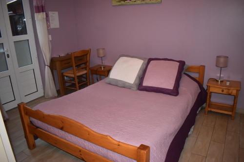 a bedroom with a bed with two pillows on it at Chez Augustin in Lacanau-Océan