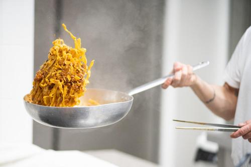 a person is holding a bowl of food at Hotel Abc in Cervia