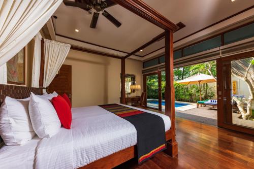 a bedroom with a bed and a patio at Serene Pavilions in Wadduwa