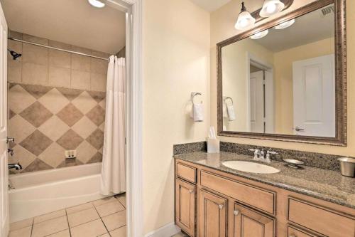 a bathroom with a sink and a shower and a mirror at Luxury 3BR Reunion Resort Condo Near Disney Golf & Pools in Kissimmee