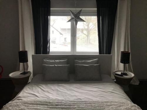 a bedroom with a bed with a large window at Apartments Centrum in Rožnov pod Radhoštěm