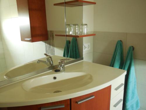 a bathroom with a sink and a mirror at B & B " De 7 Sprong " in Sevenum