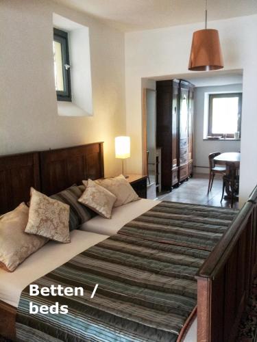 a bedroom with a large bed with pillows on it at Ferienwohnung VISHWAS in Trier