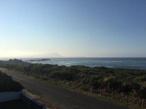 a road with a view of the ocean at Bungalow by the sea near Cape Town in Kleinmond
