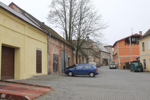 a small blue car parked on the side of a street at Pension TV in Planá