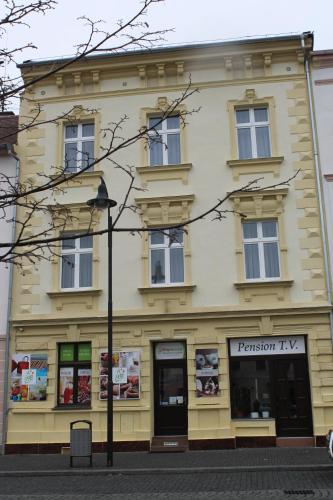 a building on the corner of a street at Pension TV in Planá