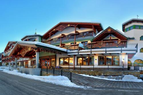 a large building on the side of a street at Kristiania Pure Nature Hotel & Spa in Cogolo