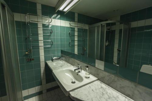a bathroom with a sink and a mirror at Hotell Alfred Nobel in Karlskoga
