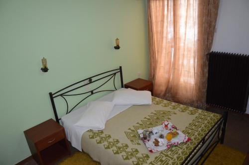 a bedroom with a bed with aspread on it at Hotel Hani Zisi in Chania