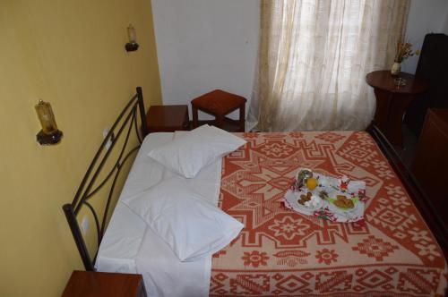 a bedroom with a bed with a plate of food on it at Hotel Hani Zisi in Chania