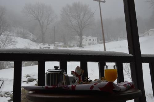 a glass of orange juice sitting on a table in the snow at Hotel Hani Zisi in Chania