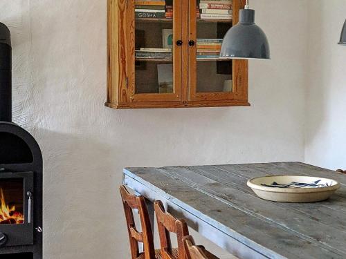 a kitchen with a wooden table and a stove at 2 person holiday home in Gilleleje in Gilleleje