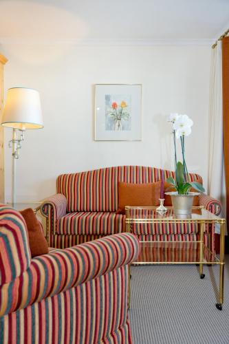 a living room with a couch and a table at Hotel Angela in Lech am Arlberg