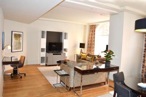 a living room with a couch and a table at Taj 51 Buckingham Gate Suites and Residences in London
