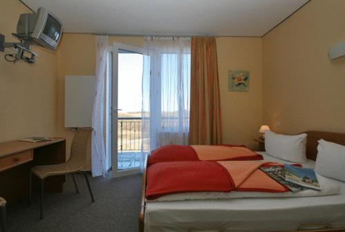 Postel nebo postele na pokoji v ubytování Dünenhotel Borkum