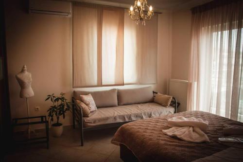 a living room with a couch and a window at API Projects Nafplio - Family Superior Apartment in Nafplio