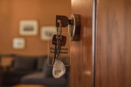 a lock on a door with a tag on it at API Projects Nafplio - Family Superior Apartment in Nafplio