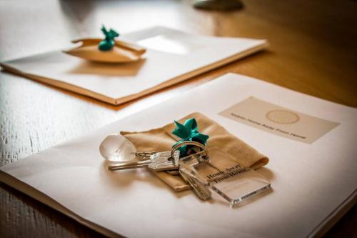 a pair of keys sitting on top of a table at API Projects Nafplio - Family Superior Apartment in Nafplio