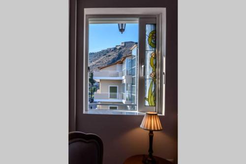 a window with a view of a building at API Projects Nafplio - Family Superior Apartment in Nafplio
