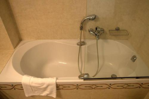 a bath tub with a faucet in a bathroom at API Projects Nafplio - Family Superior Apartment in Nafplio