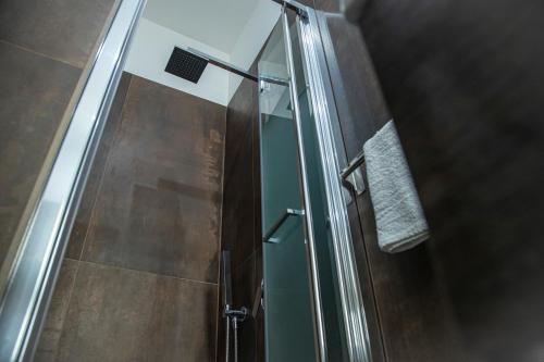 a shower with a glass door in a bathroom at House Orlando in Sferracavallo