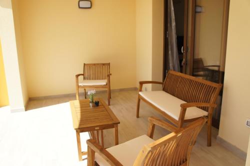 a living room with two chairs and a table at Apartment Mistral in Badesi