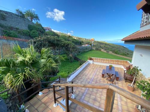 a patio with a table and a view of the ocean at Amazing Country House with Ocean View, Cueva de la Arena in Garachico