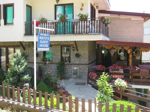 a house with a sign in front of it at Risto's Guest House in Ohrid