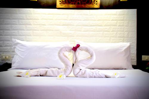 a bed with two swans made out of towels at Wan Wan Place in Ao Nang Beach