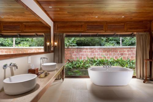 a bathroom with two sinks and two toilets at Pepper Trail in Sultan Bathery