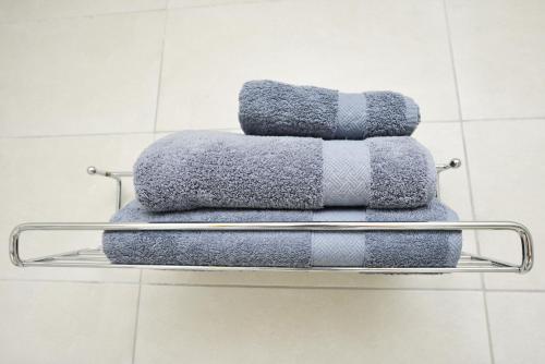 a pile of towels on a towel rack in a bathroom at Serurubele Boutique Hotel in Bushbuckridge