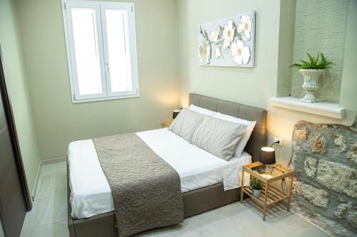 a bedroom with a bed and a window and a chair at House Orlando in Sferracavallo