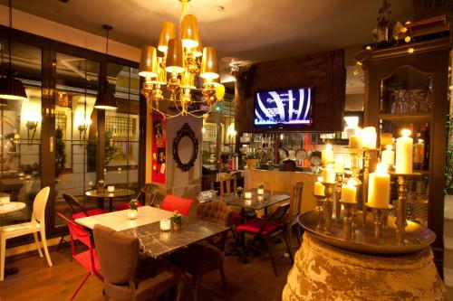 a restaurant with tables and chairs and a television at Hypnos Design Hotel in Istanbul