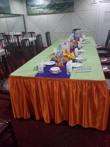 a long table with plates of food on it at Hotel Dewanekhas Skardu in Skardu