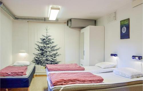 a hospital room with two beds and a christmas tree at Stunning Home In Simrishamn With Kitchen in Simrishamn