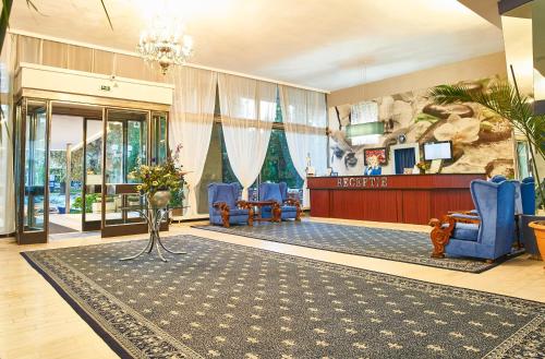 a lobby with a waiting area with blue chairs and a waiting room at Continental Drobeta Turnu Severin in Drobeta-Turnu Severin