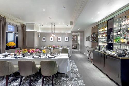 a large dining room with a table and chairs at Taj 51 Buckingham Gate Suites and Residences in London