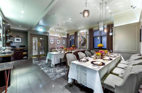 a large dining room with tables and chairs at Taj 51 Buckingham Gate Suites and Residences in London