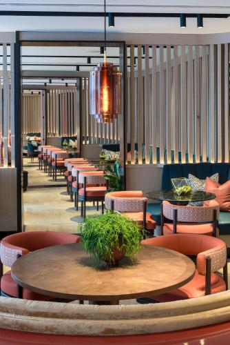 a dining room with tables and chairs and a table at The Lowry Hotel Manchester in Manchester