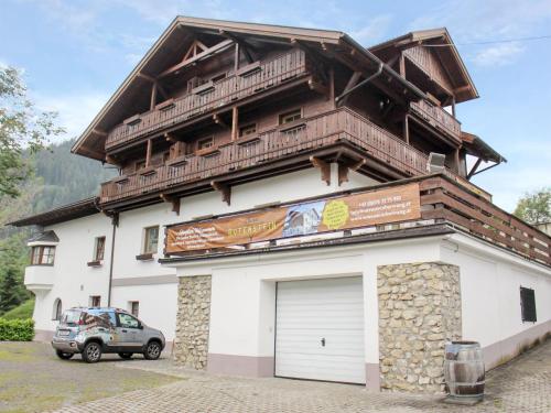a large white building with a large wooden roof at Chalet Rotenstein in Berwang