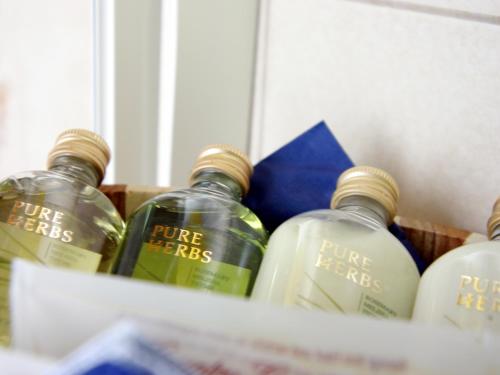 four bottles of pure herbs sitting in a basket at Sporthotel Cinderella in Obertauern