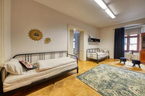 a bedroom with a bed and a couch and a rug at CityLife Residence in Bratislava