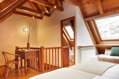 a bedroom with a desk and a bed and a window at Banhs de Arties by FeelFree Rentals in Arties