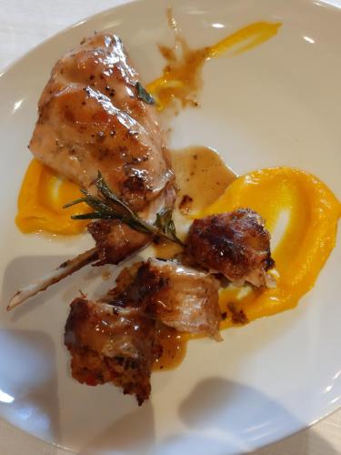 a plate of food with meat and yellow sauce at locanda della pacchiana in San Salvatore Telesino