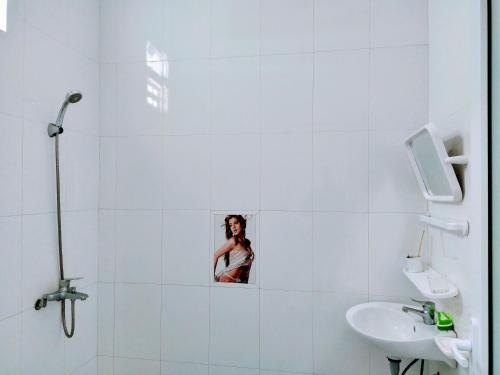 a white bathroom with a sink and a mirror at Ly Ly River in Hoi An