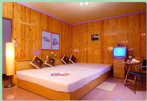 Ein Bett oder Betten in einem Zimmer der Unterkunft Fu Nong B&B