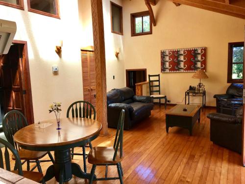 a living room with a table and a couch at YAN KEE WAY LODGE BUNGALOW in Puerto Varas