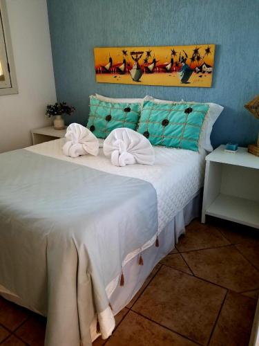 a bedroom with a large white bed with towels on it at Pousada Boutique Recanto Do Encanto - GAMBOA - Morro de São Paulo in Morro de São Paulo