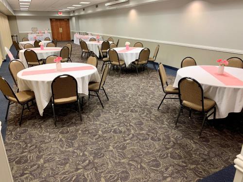 a conference room with tables and chairs and a whiteboard at AmericInn by Wyndham Mankato Event Center near MSU in Mankato